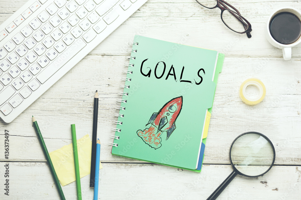 Fototapete goals text on notebook with keyboard and stationary on table