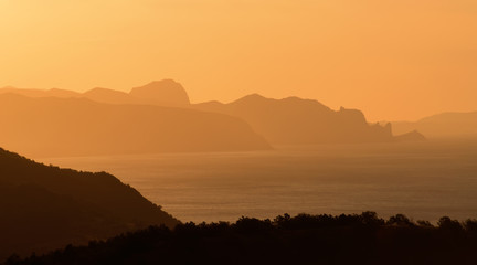 Sea coast at sunrise mountainy summer sun