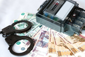 Energy meter and the handcuffs lying on Russian ruble