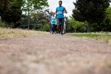 Obraz premium Athletes running race in park