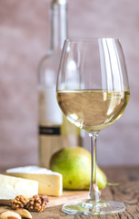 Glass of white wine with cheese and nuts
