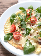 Crepes with cherry tomatoes, italian cheese and arugula