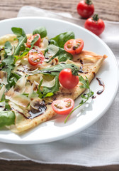 Crepes with cherry tomatoes, italian cheese and arugula