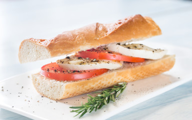Sandwich with sliced fresh tomatoes and mozzarella