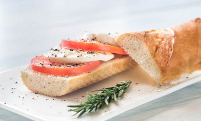Sandwich with sliced fresh tomatoes and mozzarella