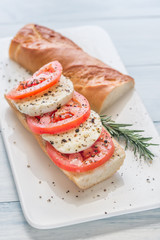 Sandwich with sliced fresh tomatoes and mozzarella