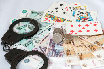 The handcuffs are on Russian banknotes and playing cards