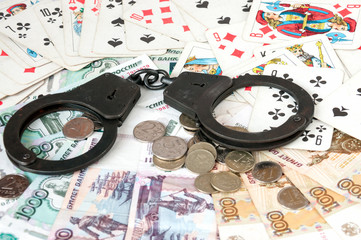 The handcuffs are on Russian banknotes and playing cards
