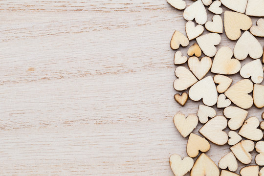 Wooden hearts, on the heart background.