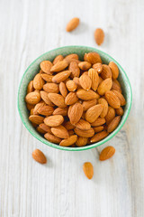 almonds in a bowl on wooden surface