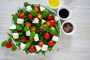 Vegetarian salad with cherry tomato, mozzarella and rucola
