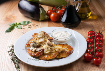 Ukrainian national dish of potatoes on a white plate on a wooden table, surrounded by decor