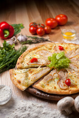 Italian pizza on a wooden table, surrounded by decor