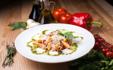white plate with Spaghetti sprinkling parmesan cheese on a wooden table, surrounded by decor