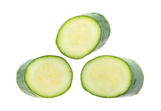 Three slices of Italian squash isolated on a white background.