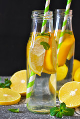 Summer drink - cold lemonade with mint on a concrete background