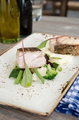 Delicious cod fillet slices, cooked to perfection, served on a bed of broccoli, olive oil dressing, spinach, green bean, pea and mashed fluffy potato. All served on a contemporary rustic table.
