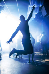 silhouette man jumped the fun and joy in club night party