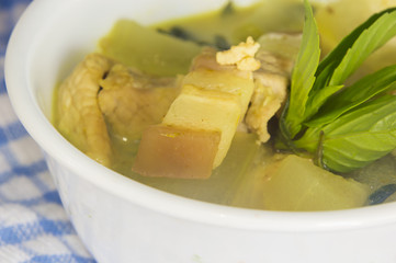 Green pork curry with old wooden background , Thai cuisine