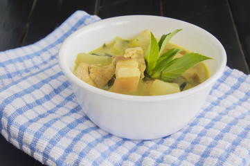Green pork curry with old wooden background , Thai cuisine