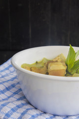 Green pork curry with old wooden background , Thai cuisine