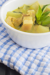 Green pork curry with old wooden background , Thai cuisine