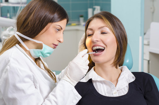 Young adult woman at dentist, braces examination 