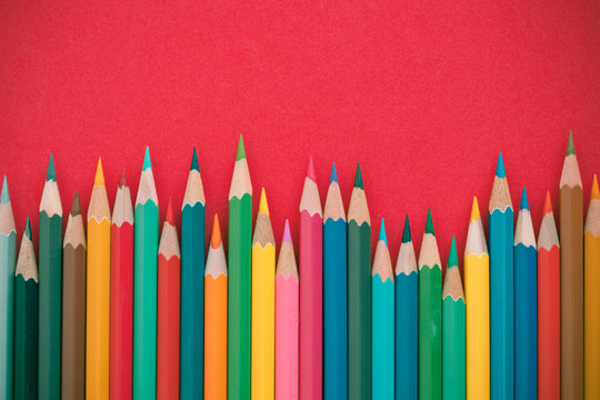 coloring pencils on a red background