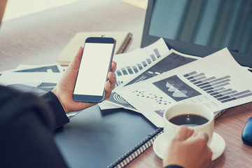 Close Up of woman hands using mobile phone and laptop computer with blank copy space screen for your advertising text message or content business in the Vintage effect.