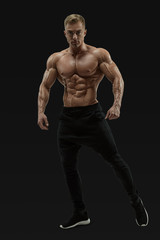 Fototapeta na wymiar Shirtless male model posing muscular core