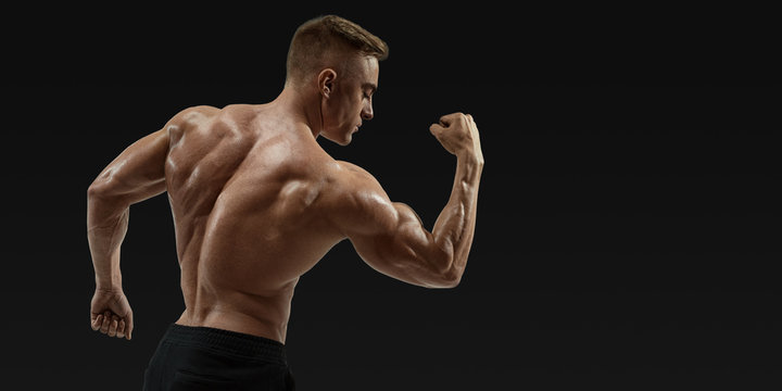 Strong back of a athletic muscular man flexing his arms