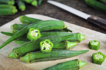 fresh whole and slice organic green okra, healthy vegetable - obrazy, fototapety, plakaty