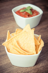 Vintage photo, Salted potato crisps and sauce in bowls, concept of unhealthy food