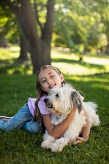 Portrait of girl with dog in park