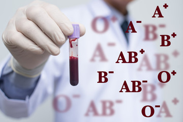 Male doctor showing whole blood in test tube and blood group ico