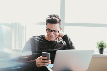 Young man checking messages on his cellphone