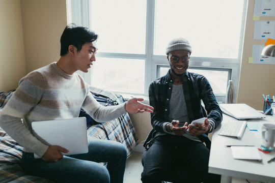 Two Friends Talking In A Dorm Room