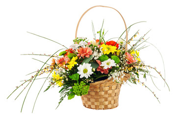 Flower bouquet from multi colored chrysanthemum and other flowers arrangement centerpiece in wicker basket isolated on white background.