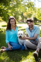 Portrait of couple with dog in park