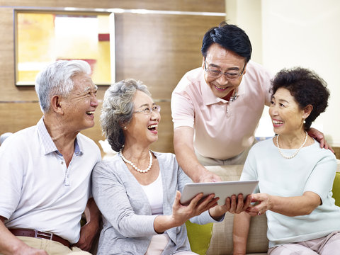 senior asian couples using tablet computer