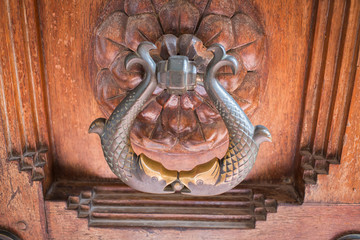 Close-up of Fish door knob on wooden door