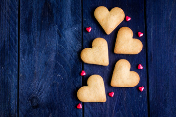  Cookies in the Shape of Heart for Valentine Day on wooden background. Love content. Top view and copy space