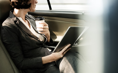 Businesswoman Using Tablet Car Inside