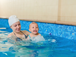 swimming little baby with mother