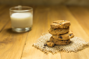 Chocolate cookies on a cloth sack on wood.