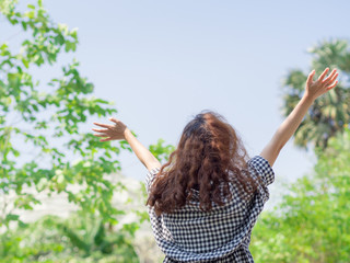 Indie girl so happy raise hands up to the sky with blurred backg