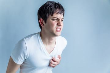 young man having a pain in his breast