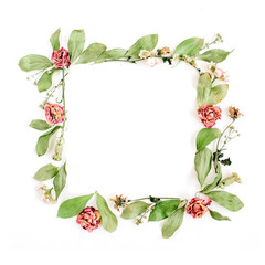 Round frame wreath pattern with roses, pink flower buds, branches and leaves isolated on white background. Flat lay, top view