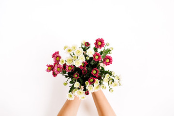 Wildflowers bouquet in girl's hands on white background. Flat lay, top view. Flowers background.