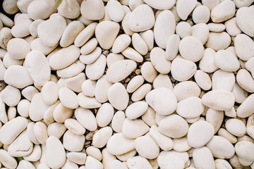 Neutral pattern of pale beige stones. Flat lay, top view